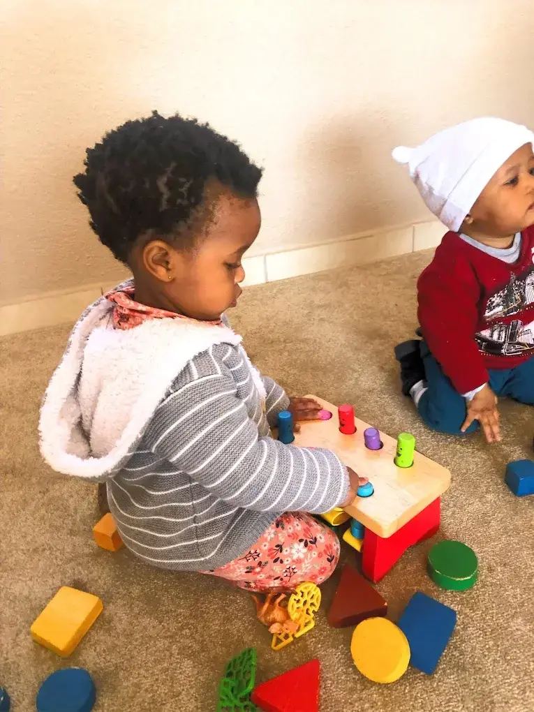 Toddlers building with blocks during themed learning